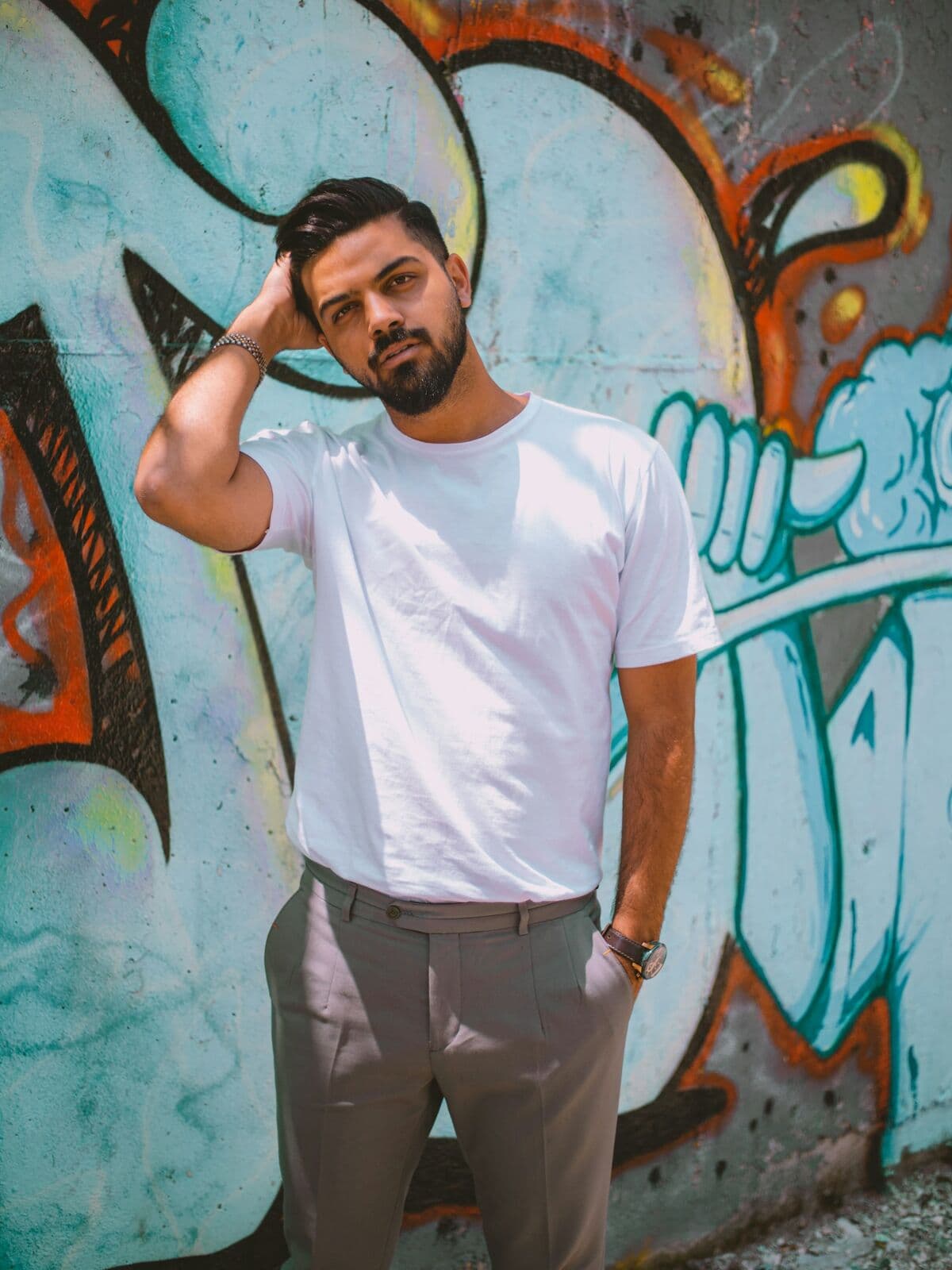 Model in a white t-shirt in front of a graffiti wall
