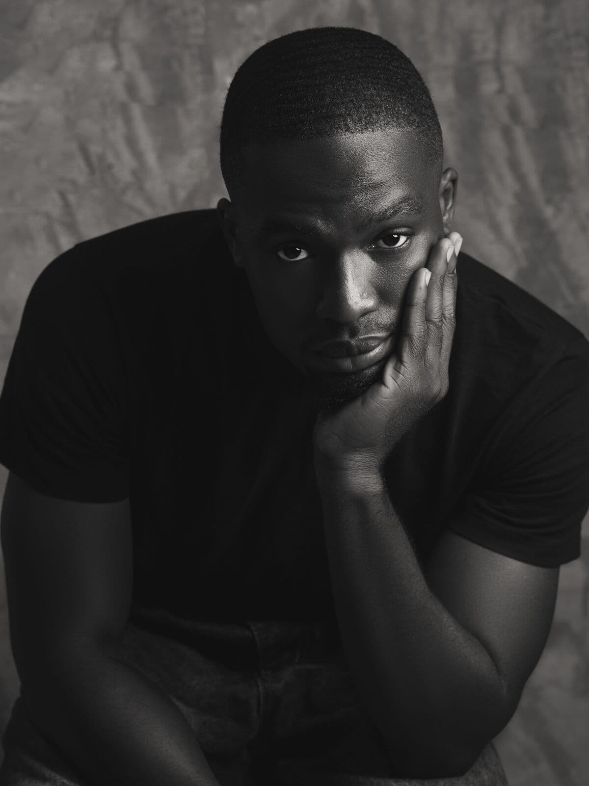 Model in a black t-shirt, monochrome studio portrait